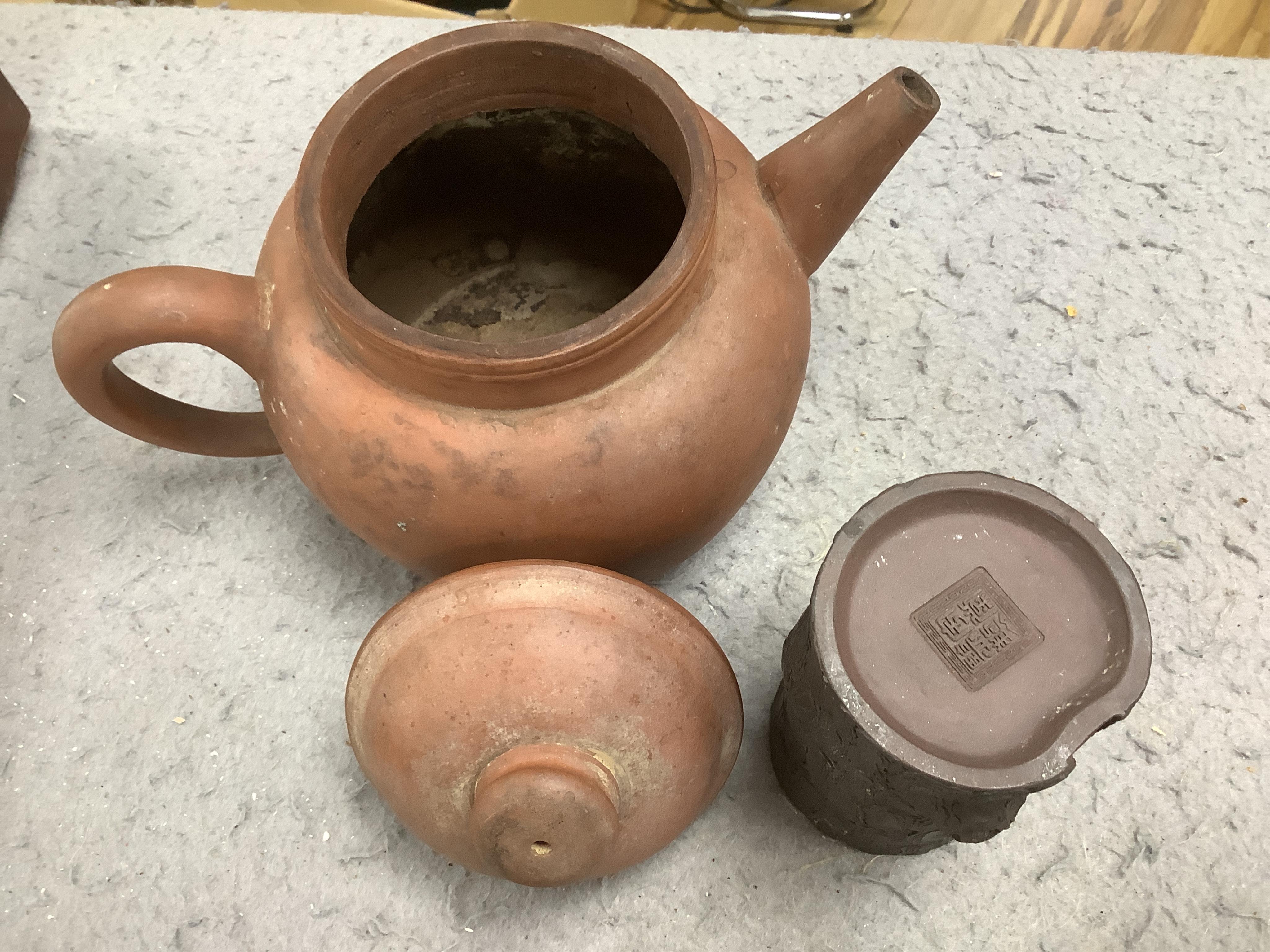 A 19th century Chinese Yixing pottery ‘tree trunk’ brush pot and three similar teapots, tallest 15cm. Condition - fair to good